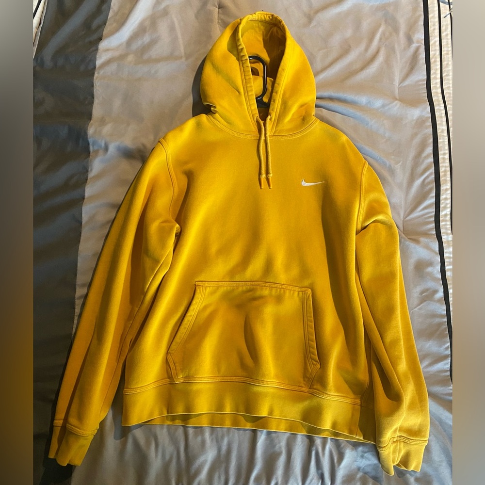 Men’s yellow Nike pullover hoodie.